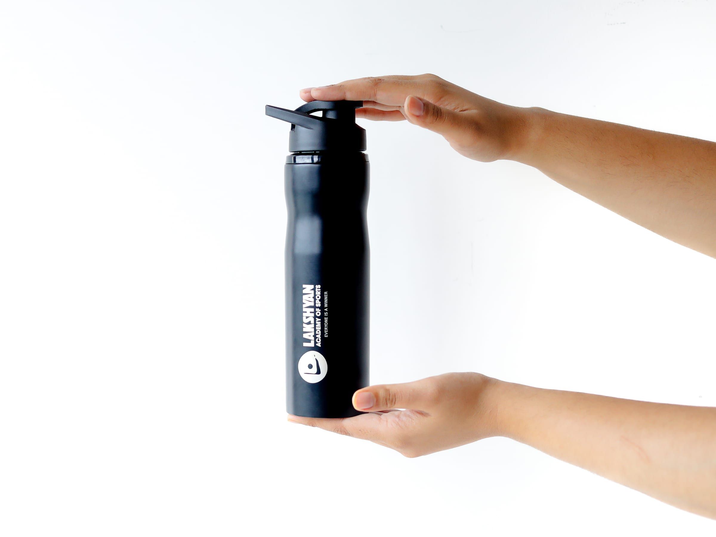 A Lakshyan water bottle held in one hand