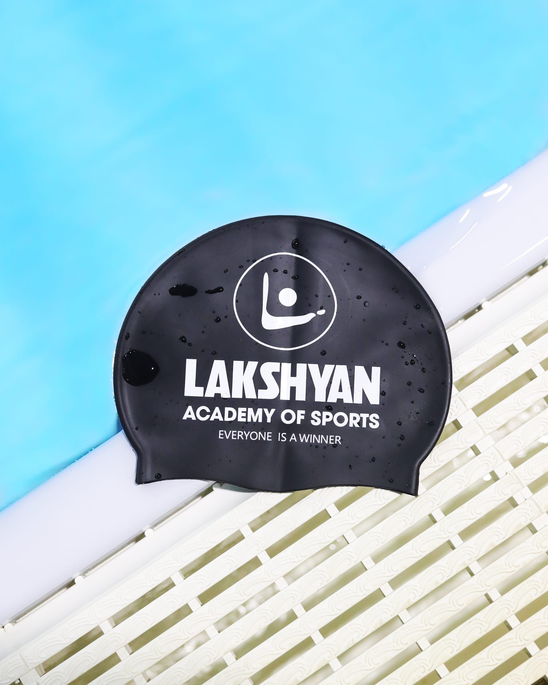 A Lakshyan swim cap on the poolside
