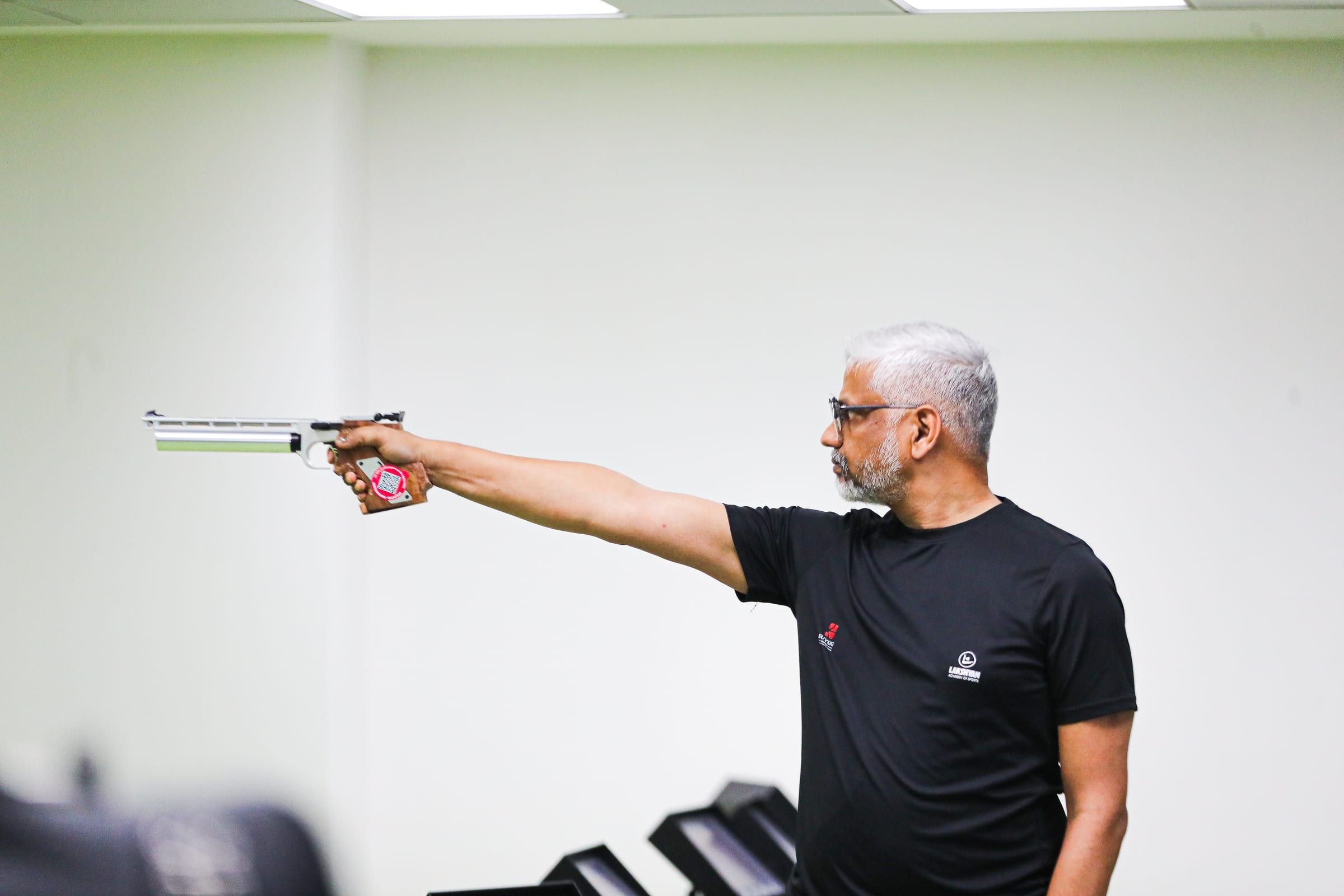 A coach at the academy shooting range
