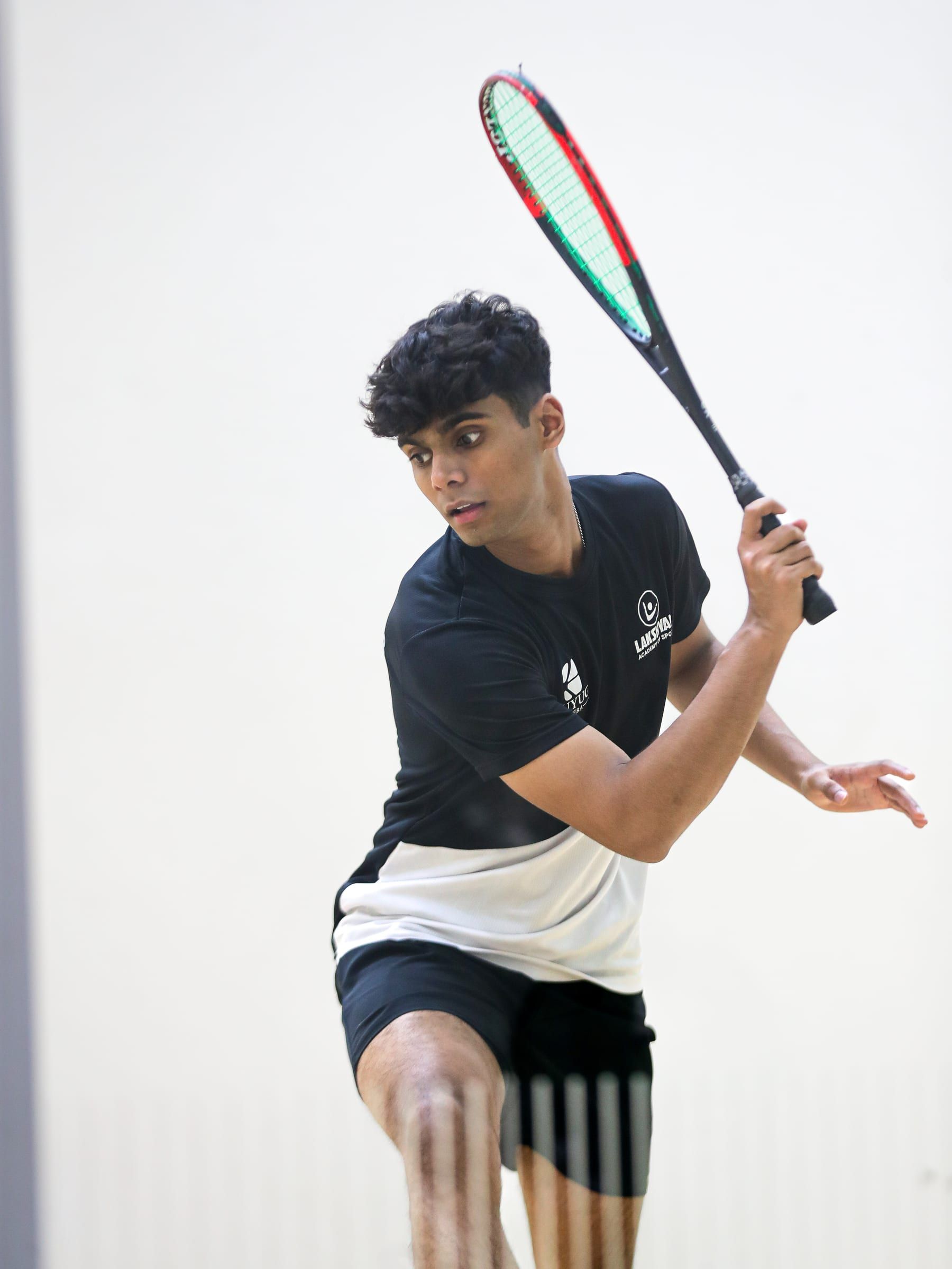 A squash player mid-swing