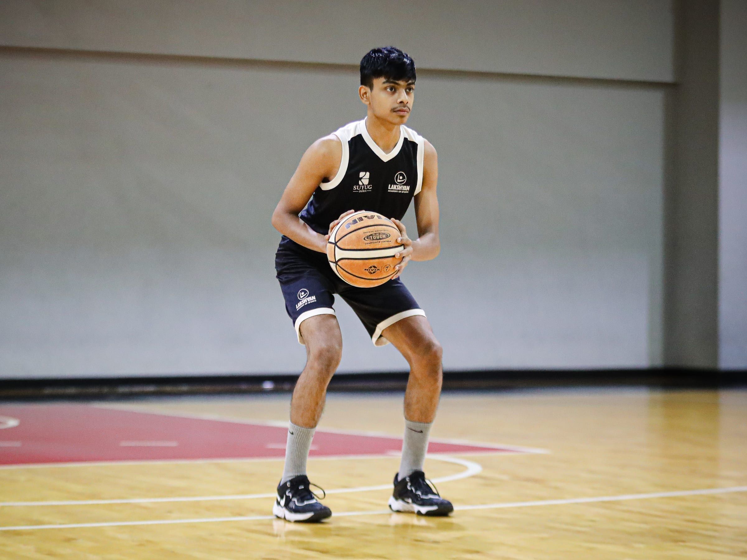 A basketball player on the indoor court